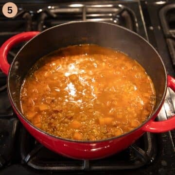 cooking soup with lentils, bacon and potatoes in a dutch oven.