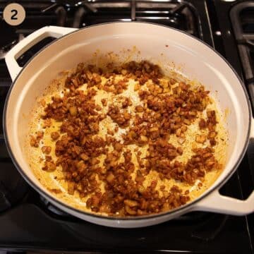 adding sweet and smoked paprika to a onions in a pot.