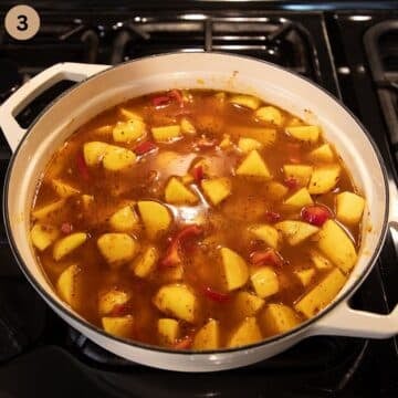 adding stock to cook potatoes for making sausage goulash in a pot.