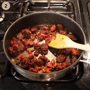 stirring chorizo slices, carrots and spices in a saucepan with a wooden spoon.