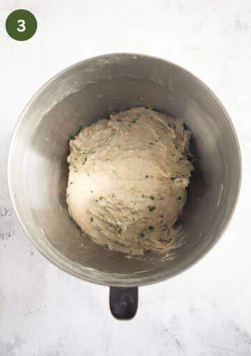 bread dough with chives in a bowl.