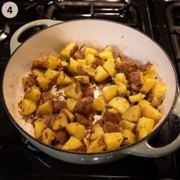 potato and kielbasa pieces cooking in a large pot.