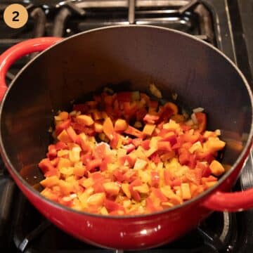 sauteing onions, carrots and bell peppers in a pot to make soup.