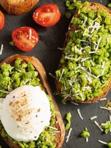 smashed peas on toast, one topped with an poached egg.