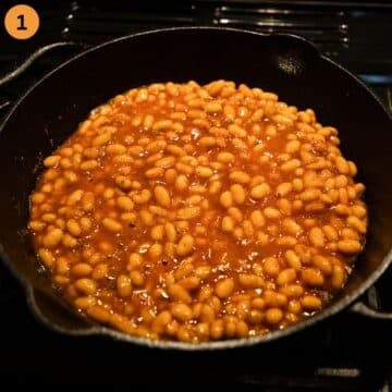 baked beans heating up in a skillet on the stove.