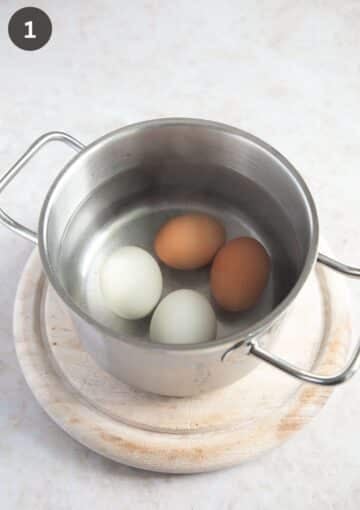 four eggs in a small pot covered with water.