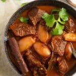 pinterest image with the title lamb stifado.