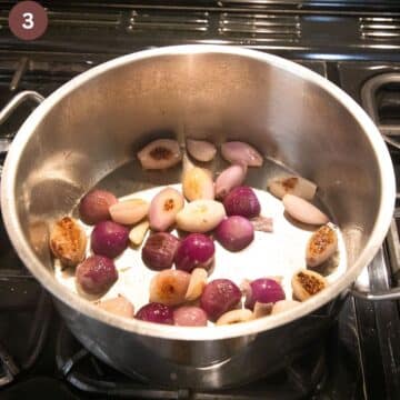 browning shallots in a large heavy-bottomed pot.