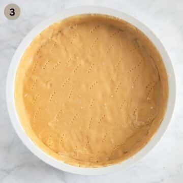 shortcrust in a baking dish poked with fork.