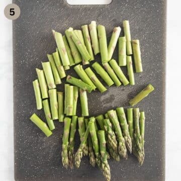 cut asparagus spears on a cutting board.