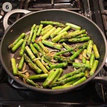 sauteing onions and asparagus in a frying pan.