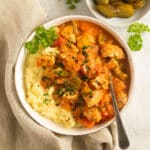 chicken goulash served with mashed potatoes in a bowl.