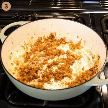 sauteing diced onions in a pot.