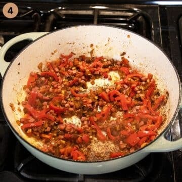 cooking paprika strips, bacon cubes and onions in a dutch oven.