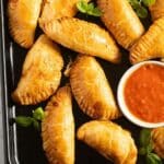 pinterest image with the title ham and cheese empanadas.