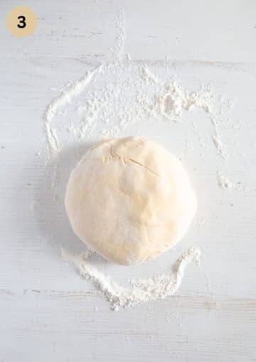a ball of dough on a floured surface.