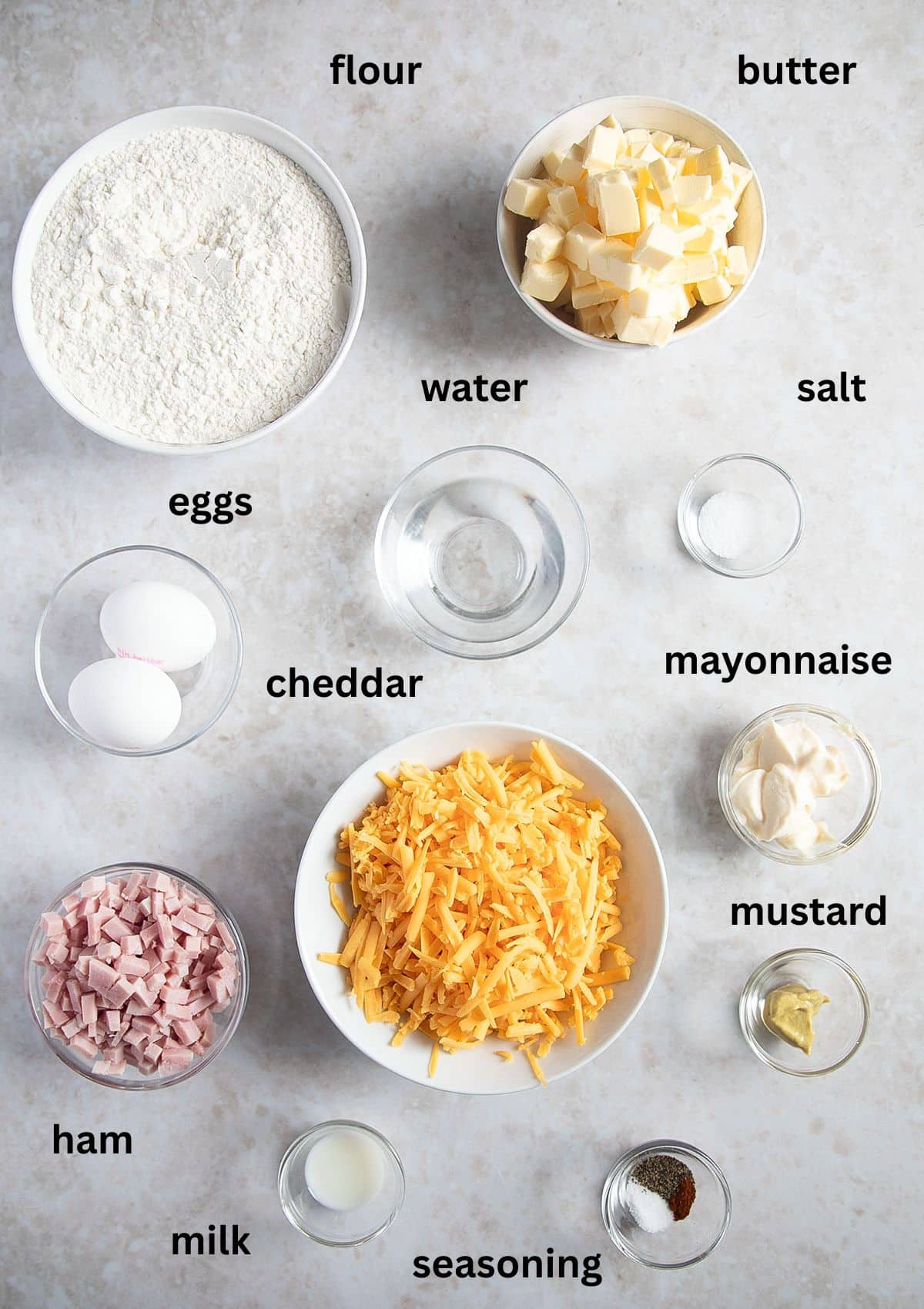 labeled ingredients for making empanadas with homemade dough and ham and cheese filling.