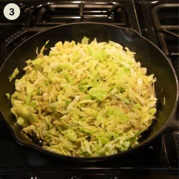 cooking eggs with cabbage in a cast iron skillet on the stovetop.