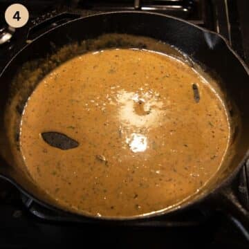 sauce with white wine reducing in a skillet.