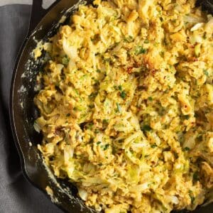 scrambled eggs and cabbage in a skillet.