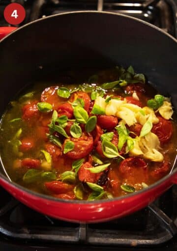 sauteing roasted tomatoes, garlic, and basil in a soup pot.