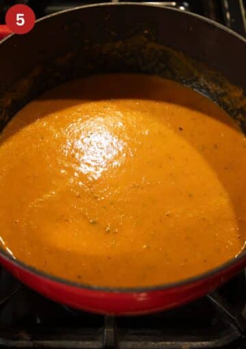 blended tomato soup with garlic in a pot.