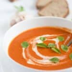 pin image with the title roasted tomato garlic soup.