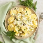 sour cream potatoes garnished with herbs on a plate.