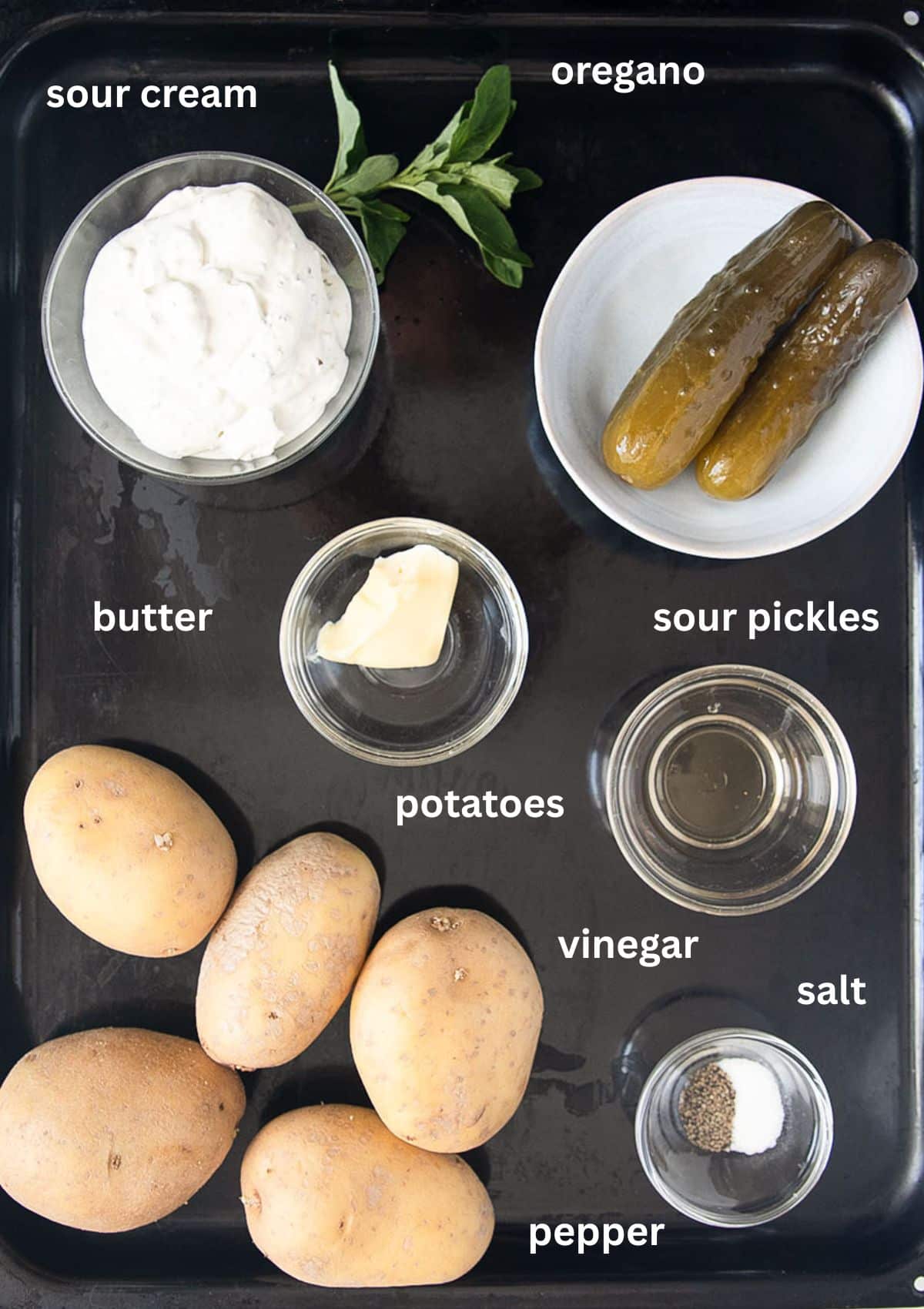 labeled ingredients for coooking potatoes with sour cream, pickles, and herbs.