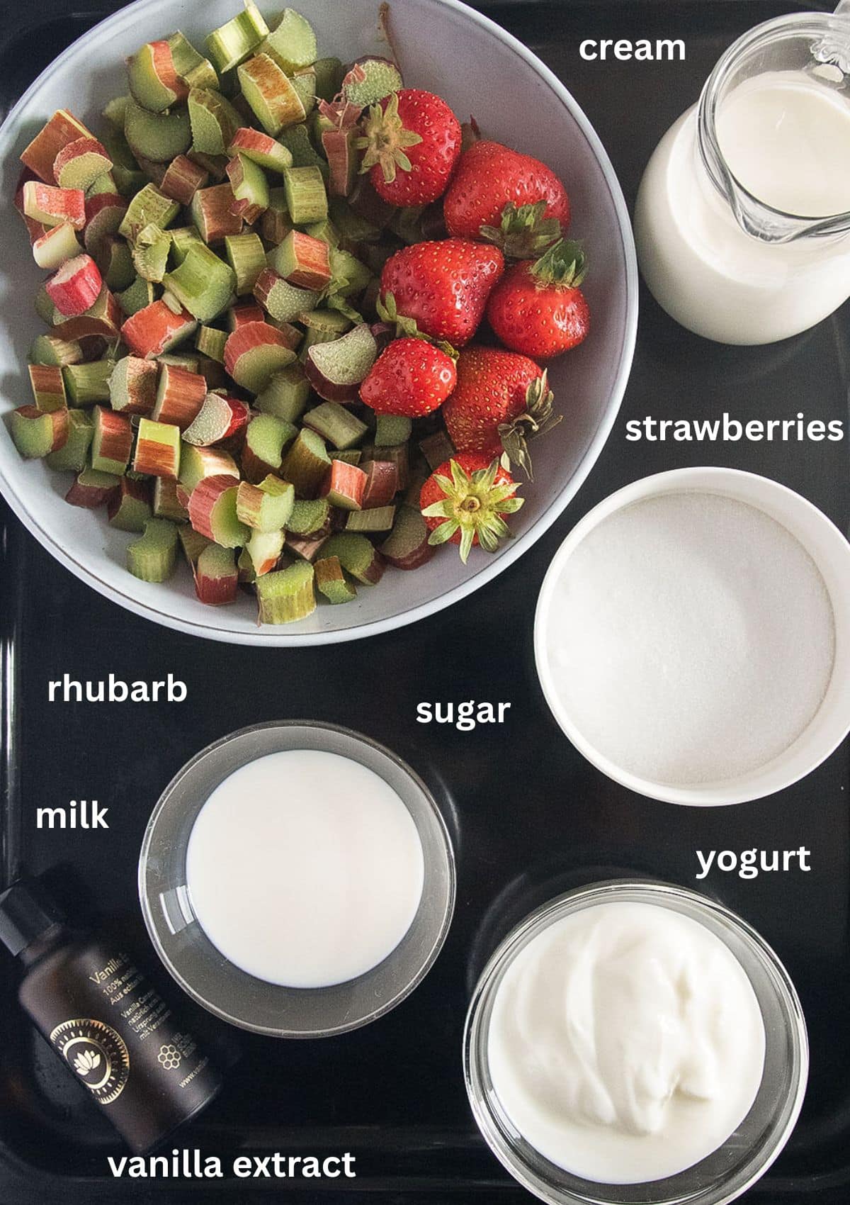 labeled ingredients for making ice cream with rhubarb, strawberries, yogurt, milk, cream and vanilla.
