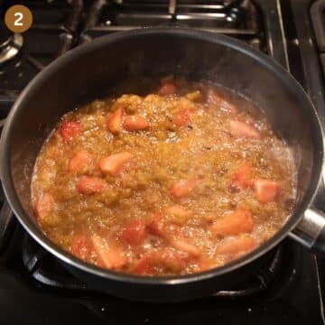 simmering rhubarb and strawberries in a saucepan.