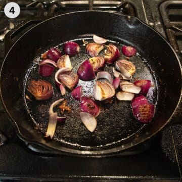 sauteing thick slices of red onions in a cast iron skillet.