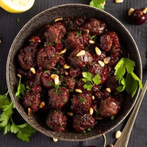 cherry meatballs sprinkled with pine nuts and parsley.