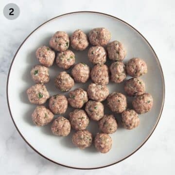 small, uncooked meatballs on a plate.