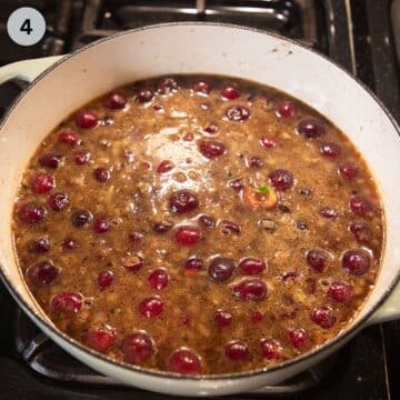 making cherry sauce for meatballs in a dutch oven.