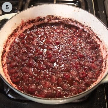 cherry sauce for meatballs simmering in a dutch oven.