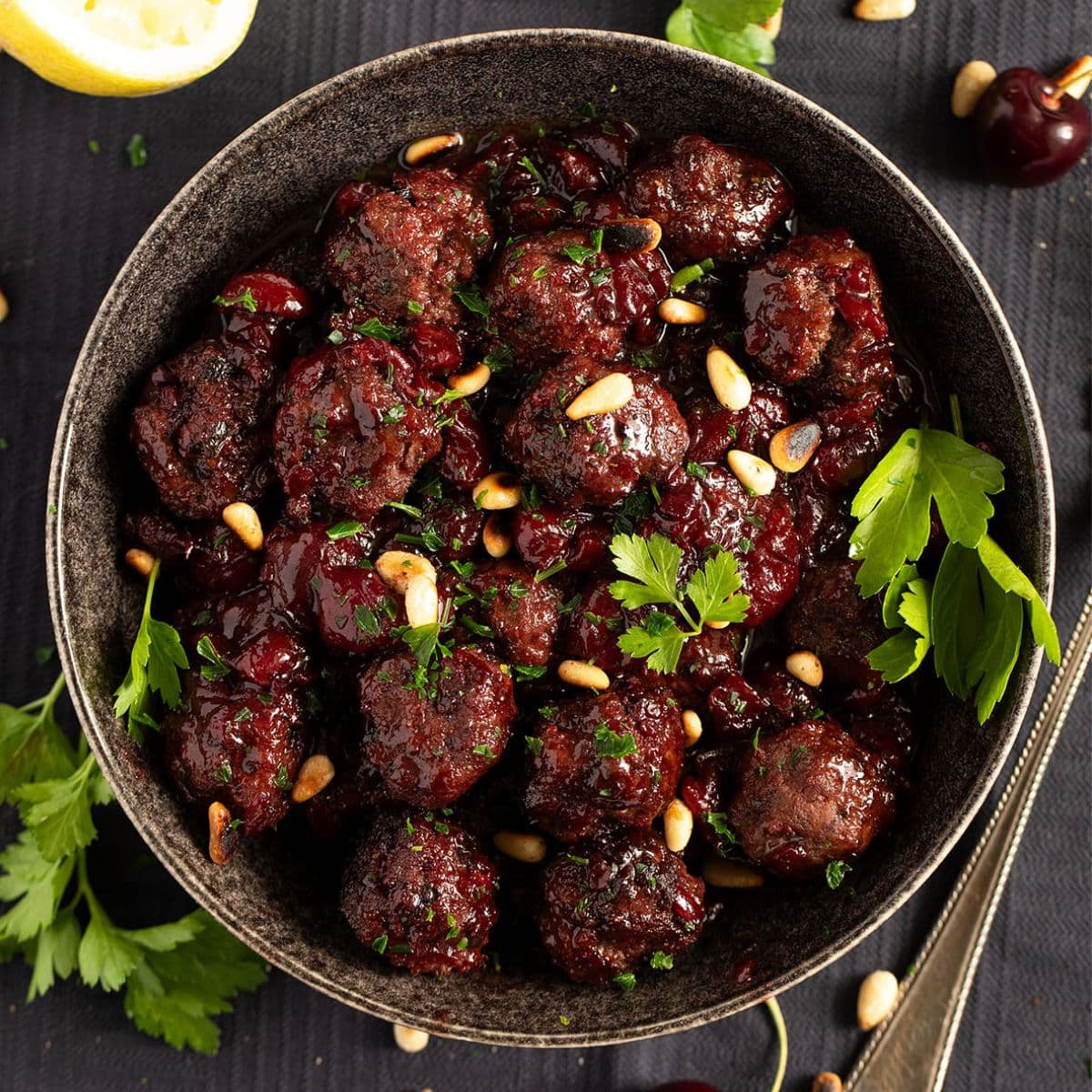 cherry meatballs sprinkled with pine nuts and parsley.