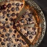 cherry tart with ground almond filling and sweet cherries on a vintage platter.