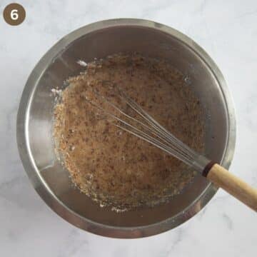 whisking the ground almond, sugar, and egg filling for cherry tart.
