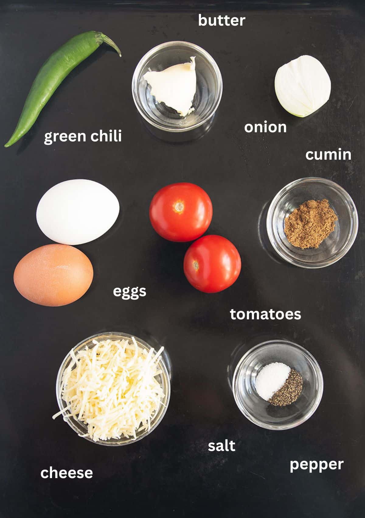 labeled ingredients for making chili omelet with cheese and spices.