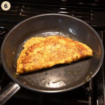 a folded omelet in a skillet.