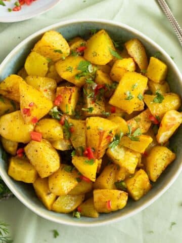 lebanese potatoes with fresh chili sauce in a bowl.