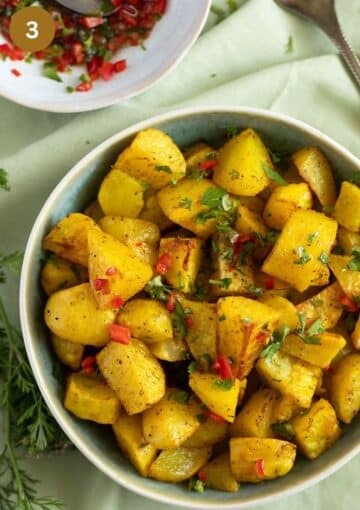 batata harra potatoes drizzled with chili sauce in a bowl.