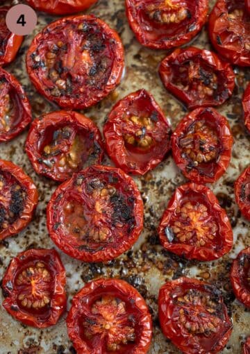 many roasted tomato halves shrivelled and collapsed on a baking sheet. 