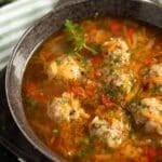 pin image of pork meatball soup with vegetables.