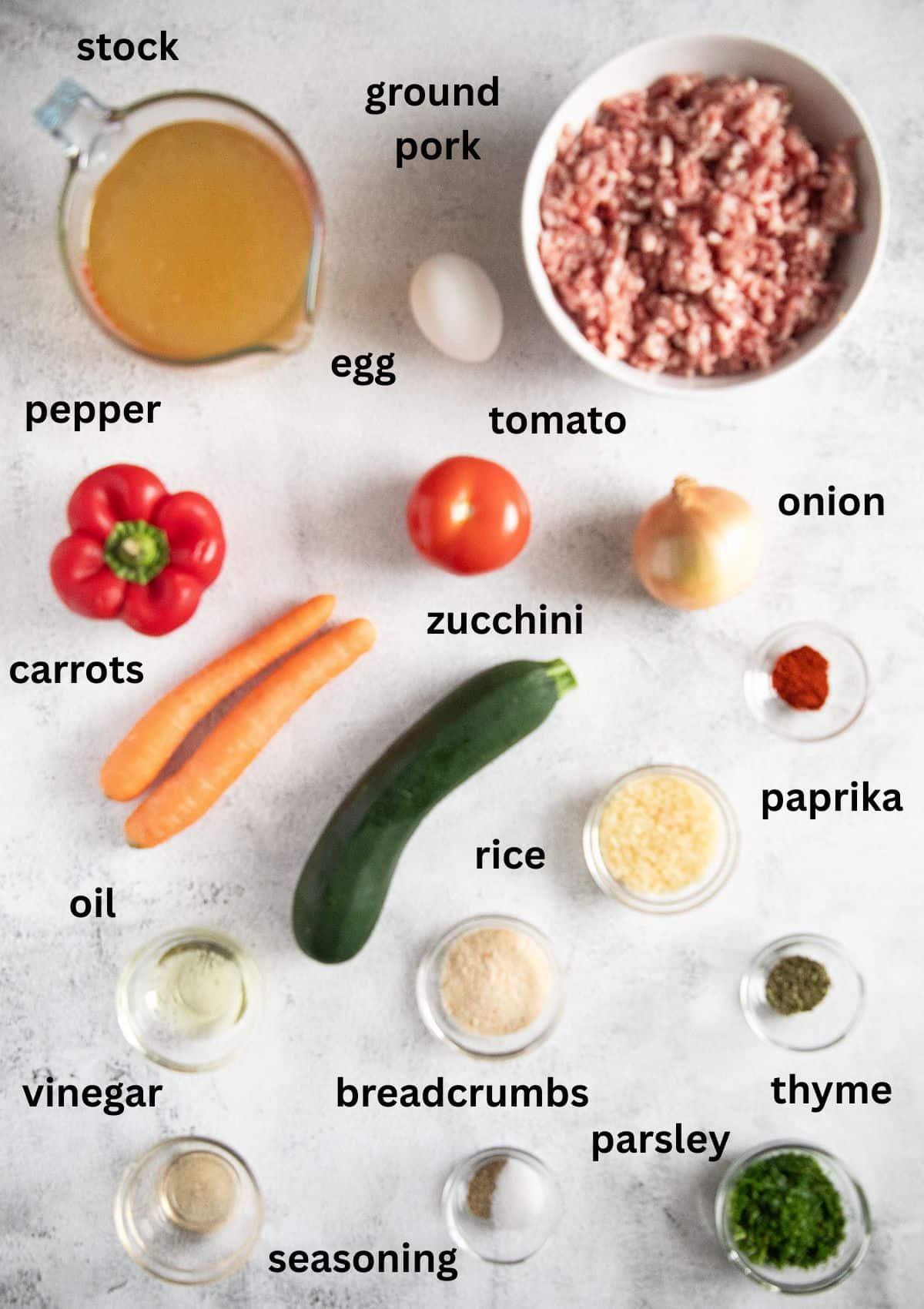 labeled ingredients for making soup with pork meatballs, stock and vegetables.