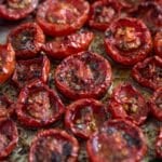slow-roasted tomatoes collapsed and charred on a baking dish.