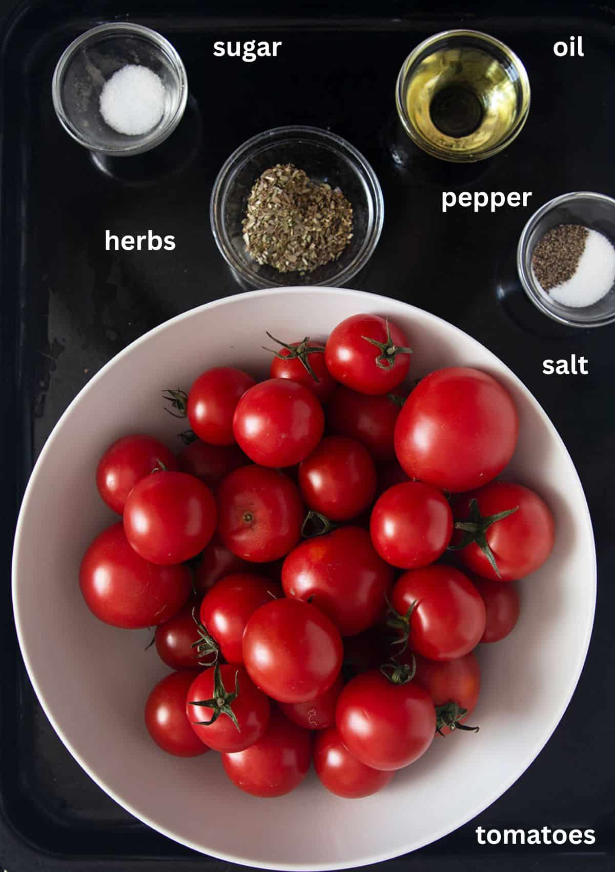 labeled ingredients: bowl with small tomatoes, bowls with salt, pepper, herbs and oil.