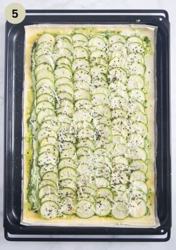 unbaked zucchini tart with puff pastry on a baking sheet.