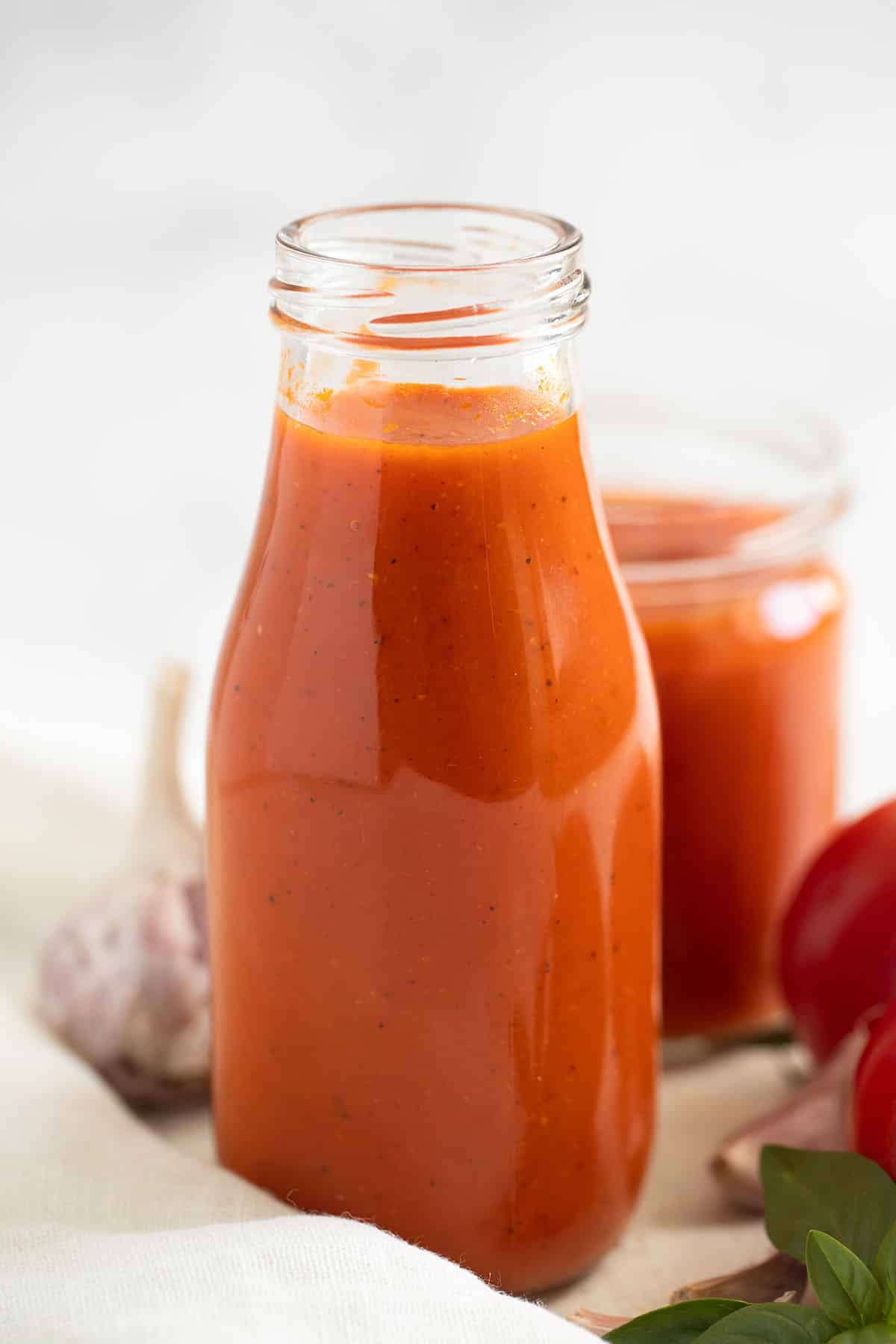a bottle and a jar full of homemade tomato ketchup.